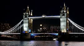 Tourists and Londoners enjoy spectacle of September's Harvest supermoon as it rises from behind Tower Bridge