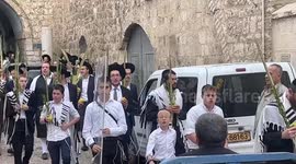 Palestinians protest as Orthodox Jews pray during the celebration of Sukkot, the Feast of the Tabernacles, at the old city of Jerusalem