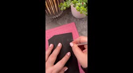 Girl decorates her phone cover with Alice in Wonderland Themed scrap booking