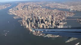 Watch a plane's stunning descent with the majestic Manhattan skyline as the backdrop. It's a breathtaking blend of aviation and iconic cityscape