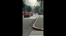 Hyper-isolated rain shower drenches only half of busy road