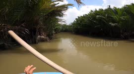 Tourists paddle through Thai river on Vietnam-inspired basket boats