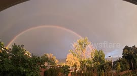 Timelapse of stunning double rainbow beaming over Utah city