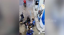 Motorcycle catches fire while filling up at petrol station in Laos