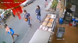 Passing motorcycle rider hits car door and falls over into gutter