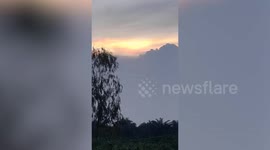Beautiful sunset illuminates sky in rural Thailand