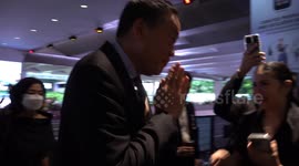 Thai Prime Minister visits shopping mall shooting scene as flowers are laid