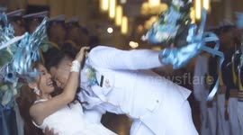Bride's back bending wedding kiss goes wrong when she topples over