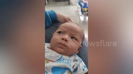 Sleepy baby gives mum side eye while looking annoyed