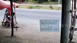 Motorcycle rider demolishes street stall with boy sleeping beside it