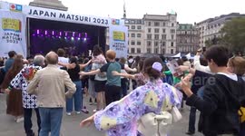 Crowds engage in exercise routine at Japan Matsuri 2023 celebrations in Trafalgar Square - London
