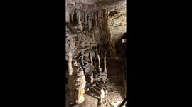 Walk through the stunning Postojna Cave stacked with intricate stalactites