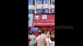 Heroic Chinese man holds up boy hanging from second-floor window until his parents return home