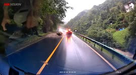 Terrifying moment massive boulder tumbling down mountain narrowly misses SUV in China
