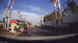 Umbrella flies from back of motorcycle into car driving behind