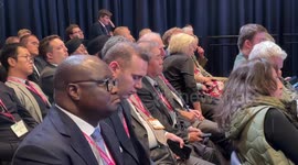 People listen to Sunak's keynote Conservative Party conference speech in Manchester, UK