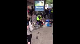 British policeman playing drums on pots and pans on the street