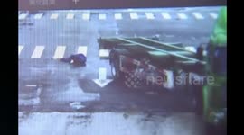 Biker escapes being run over by massive lorry