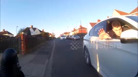 Moment BMW driver leans out of window 'to push passing cyclist'