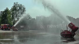 Remote control vehicles spray water into the air to reduce air pollution