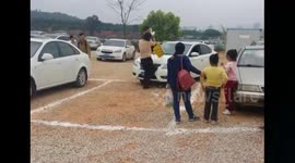 In order to get parking space, woman puts child onto another woman's car
