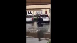 Man rides shopping trolley in bizarre attempt to avoid Dubai floodwater