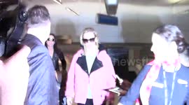 Actress January Jones signs autographs for fans as she arrives at LAX Airport