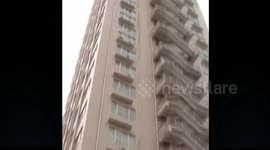 Stairs are built outside a tall building in China