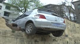 Driver tries to reverse, smashes through wall