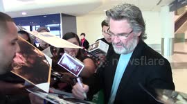 Kurt Russell signs autographs for collectors as he arrives at LAX Airport in Los Angeles, Ca