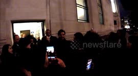 Oscar Isaac poses for pictures with fans in London
