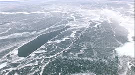 Dramatic drone footage of islands in semi-frozen lake
