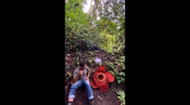 3# man enjoy drinking coffee near the rare huge corps flower in full bloom in Indonesian rainforest