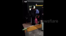 Passengers attempt to squeeze onto packed trains as millions travel during China's holiday week