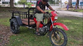 Local rides custom-made motorcycle trailer around lawn