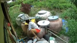 Wind blows open door and smacks woman's face as she cleans