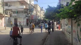 Palestinians parade through Gaza streets on Israeli military vehicle following rocket attacks