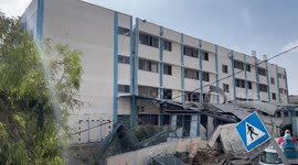 Palestinians inspect the ruins of a school destroyed in Israeli airstrikes in Gaza city