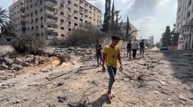 Palestinians inspect the ruins of residential tower destroyed in Israeli airstrikes on Gaza