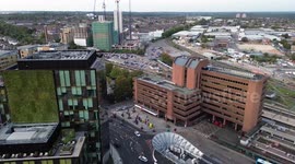 Aerial Flight view approaching Watford Junction station Trains and commuters