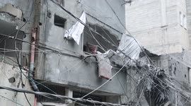 Palestinian family inspect ruins of their home destroyed by Israeli strike
