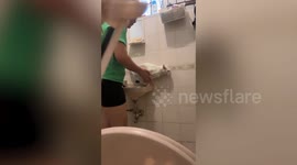 Cat whines like a baby having a bath in the sink