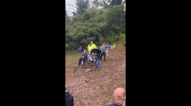 Woman Slips on Muddy Slope