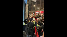 Police getting bottles and cans thrown at them by freedom Palestine