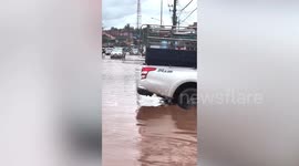 Drivers battle through severe flood covering road in northern Thailand