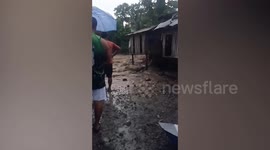 Raging flood surges through town during monsoon storm in the Philippines