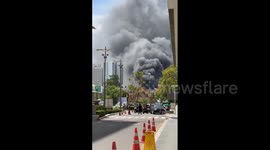 Thick smoke billows into air as fire rips through market in Bangkok