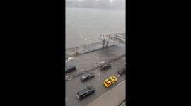 A capture of the cars navigate through a flooded section of the FDR in Manhattan