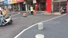 Toddler rides cardboard box attached to electric hoverboard