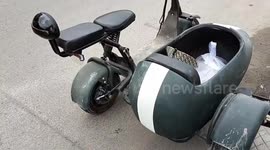 Cool electric motorcycle with capsule-shaped side car amuses tourist in Cambodia